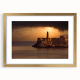 Abstract art print of a Caribbean scene in muted blue and green tones, framed in gold, ideal for dining room decor.