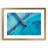 Abstract art print of a Caribbean scenery in muted blue and green tones, framed in gold, ideal for dining room decor.