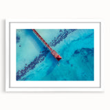 Textured abstract art print of Caribbean scenery in muted blue and green tones, framed with a white mat.