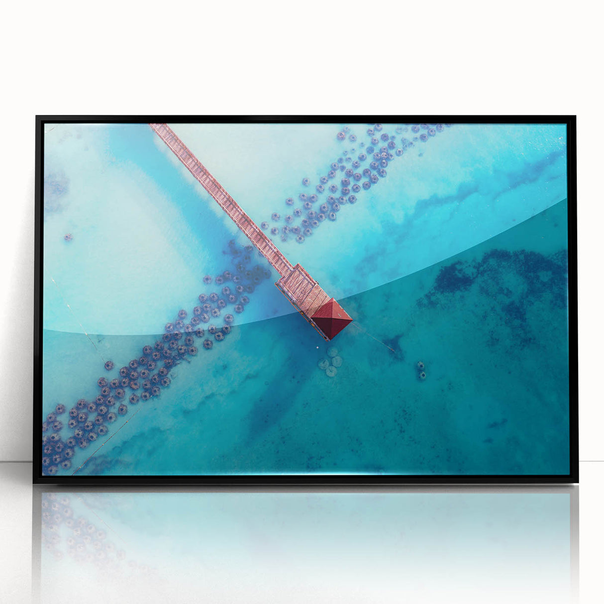 Large abstract wall art depicting Caribbean scenery in muted blue and green tones, framed in black acrylic.
