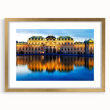 Abstract art print of a European landscape in muted gold and green tones, framed with a gold mat.