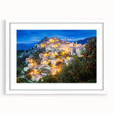 Textured abstract art print of a Corsican landscape in muted earth tones on a framed white mat, suitable for bedroom decor.