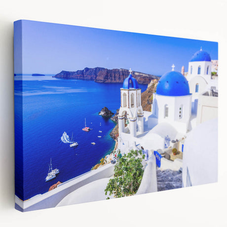 Large art print of Santorini scenery on stretched canvas, showcasing white buildings and blue domes.