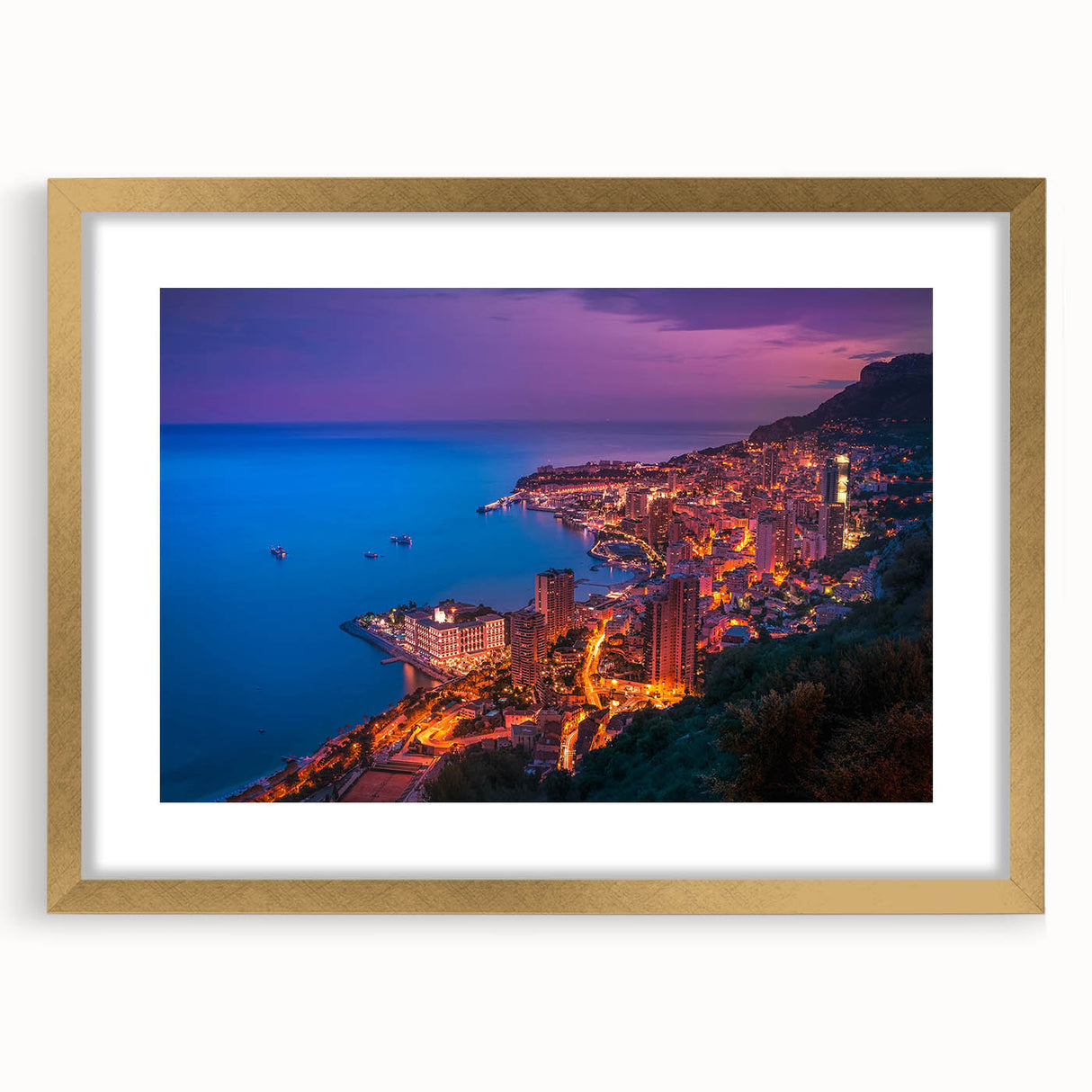 Abstract art print of European Monaco scenery in muted gold and blue tones, framed with a gold mat.