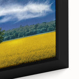 Close-up of a textured black wall art piece depicting a colorful European scenery on a framed canvas.