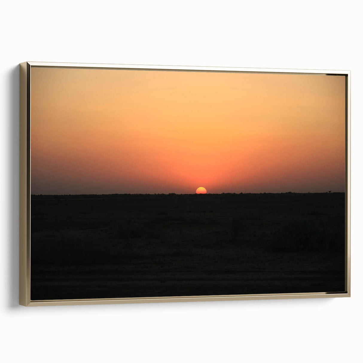 Framed canvas featuring a vintage-style landscape painting of a Middle Eastern scene in muted gold and black tones.
