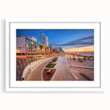 Abstract art print of Tel Aviv skyline in muted blue and gray tones on a framed white mat, ideal for dining room decor.