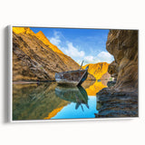 White-framed canvas featuring vintage poster art of an Omani landscape in vibrant colors, ideal for living room decor.