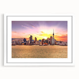 Abstract art print of Auckland skyline in muted blues and greens on a white framed canvas, suitable for dining room decor.