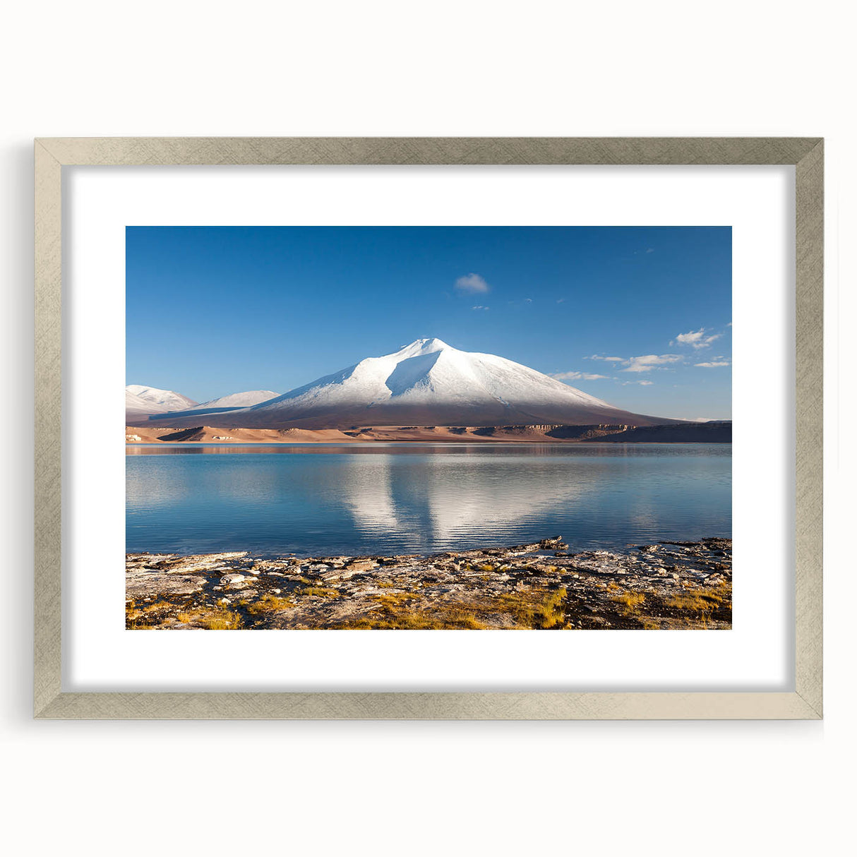Textured abstract art print of a Chilean landscape in muted earth tones, framed in silver, suitable for bedroom decor.