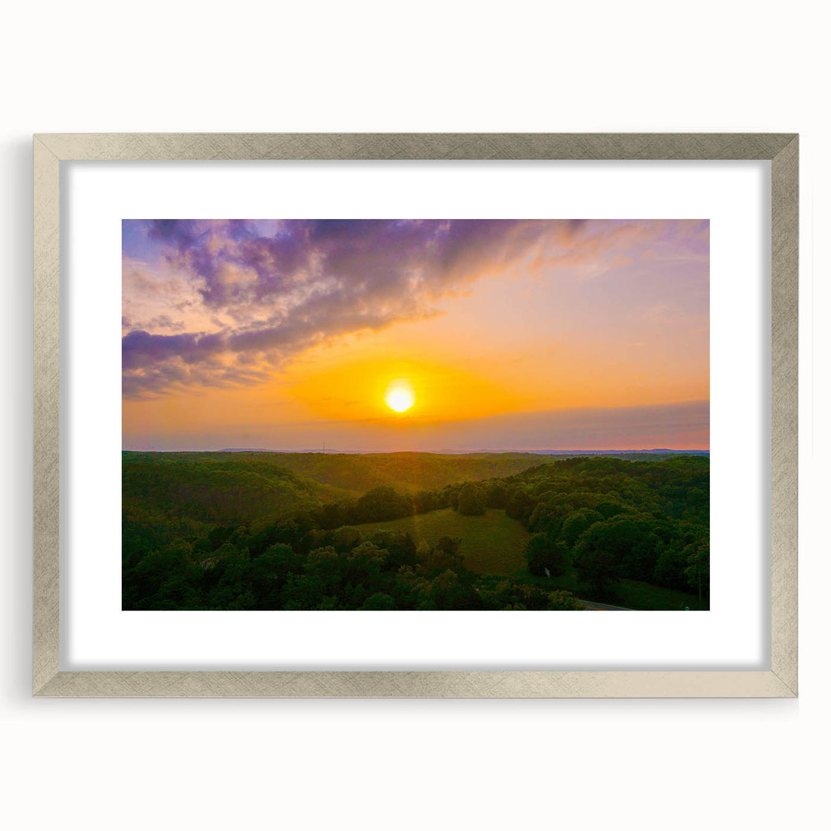 Textured abstract art print of Arkansas scenery in muted earth tones, framed with a silver mat, suitable for bedroom decor.