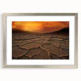 Textured art print of Death Valley in muted earth tones on a silver-framed canvas, suitable for bedroom decor.