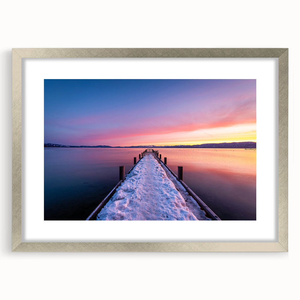 Textured art print of Lake Tahoe in muted blue and green hues on a framed silver mat, ideal for bedroom decor.