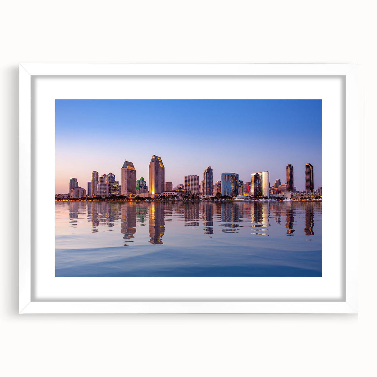 Abstract art print of San Diego skyline in muted blue and gray tones, framed in white, ideal for dining room decor.