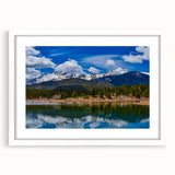 Abstract art print of Colorado Springs in muted green and blue shades on a white framed canvas.