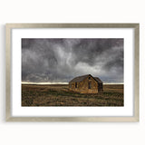 Textured art print of abstract Kansas scenery in muted earth tones on a framed silver mat, ideal for bedroom wall decor.