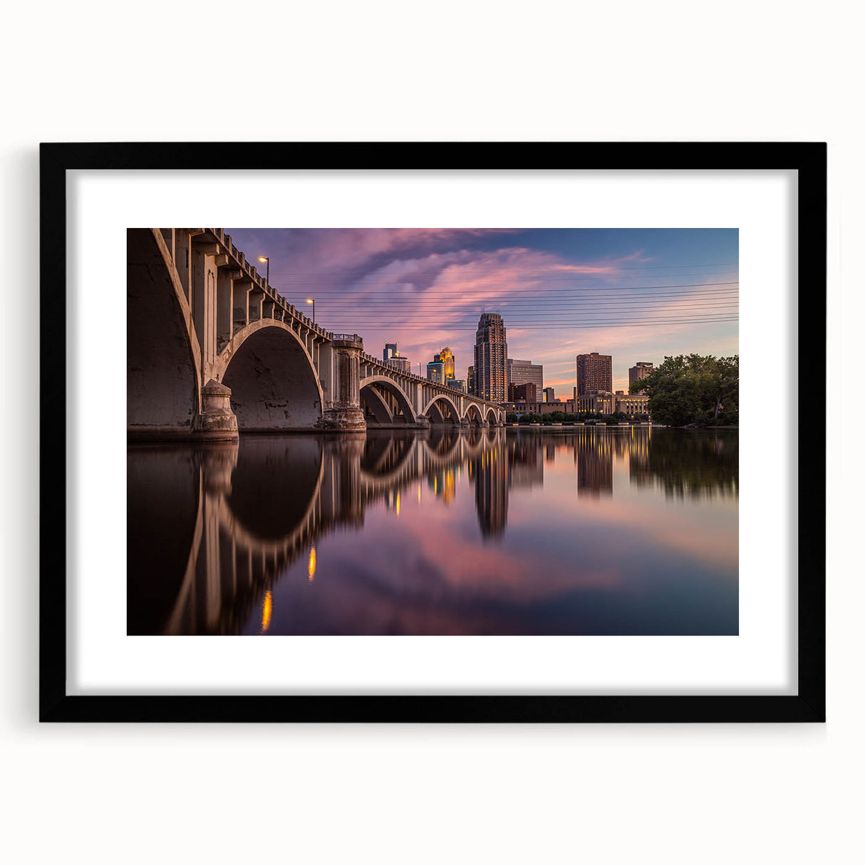 Extra large abstract art print of Minneapolis skyline in vibrant, colorful hues on a black framed canvas.