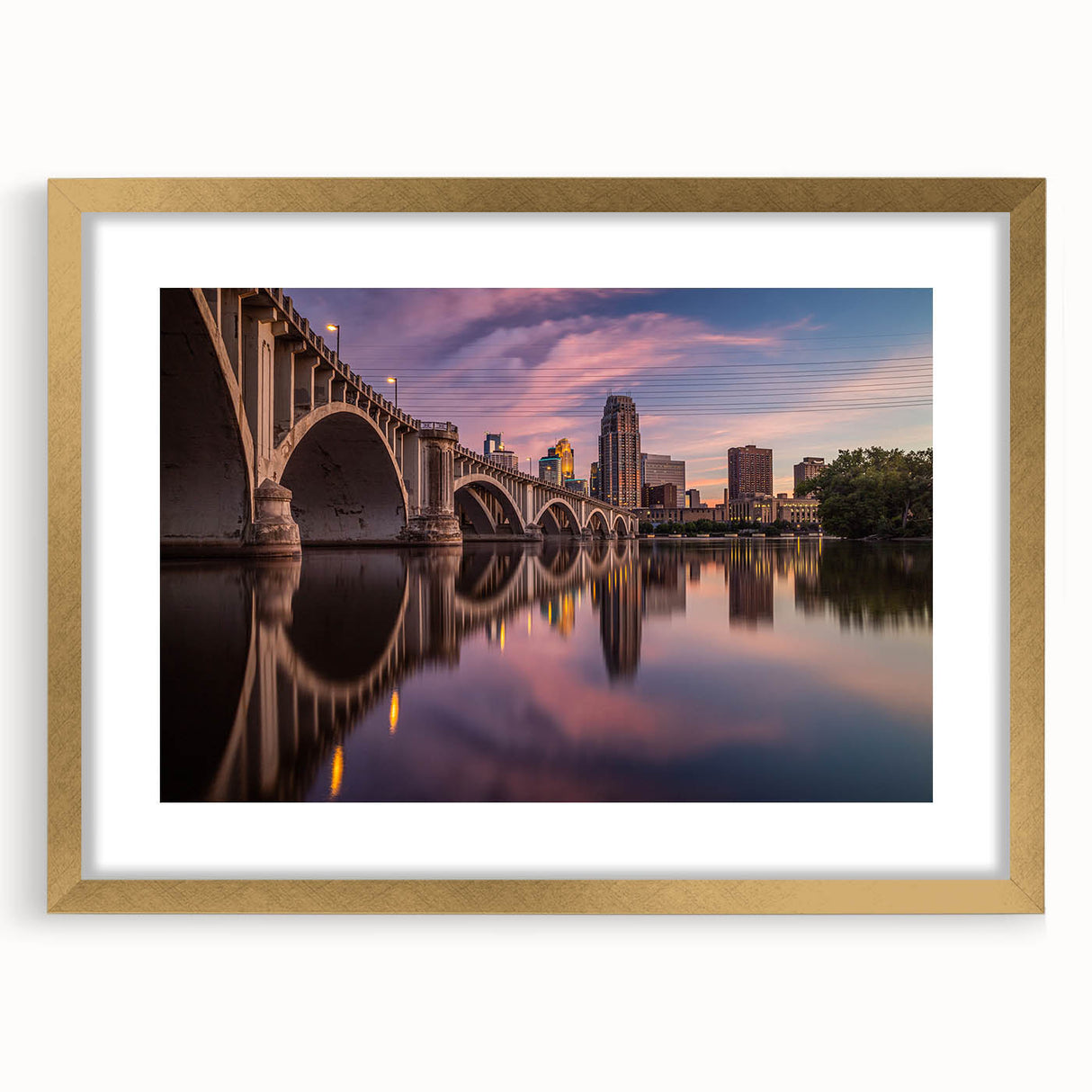 Extra large abstract art print of Minneapolis skyline in gold frame, featuring textured brush strokes in muted earth tones.