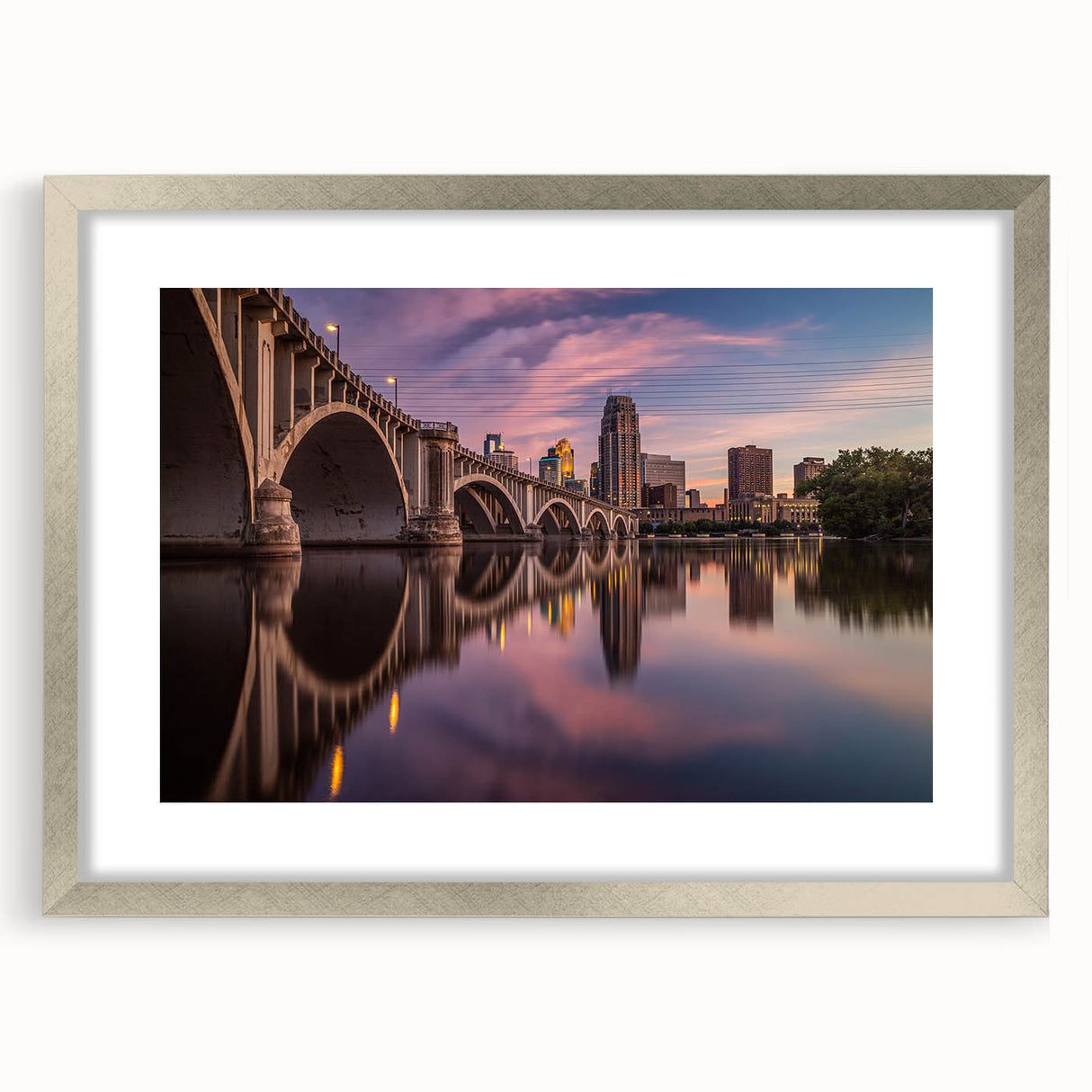 Textured abstract art print of Minneapolis skyline in silver frame, with muted gray and blue tones, ideal for bedroom art.