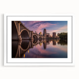 Abstract art print of Minneapolis skyline in muted gray and blue tones on a framed white mat, ideal for dining room art.