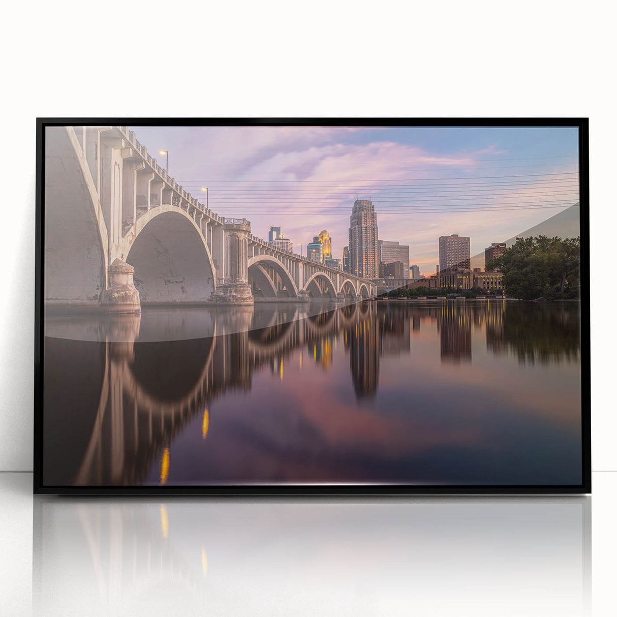 Large abstract wall art depicting the Minneapolis skyline in muted gray and blue tones on a framed acrylic print.