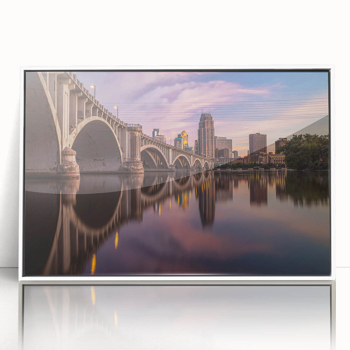 Art deco poster of Minneapolis skyline in muted blue tones on framed acrylic.
