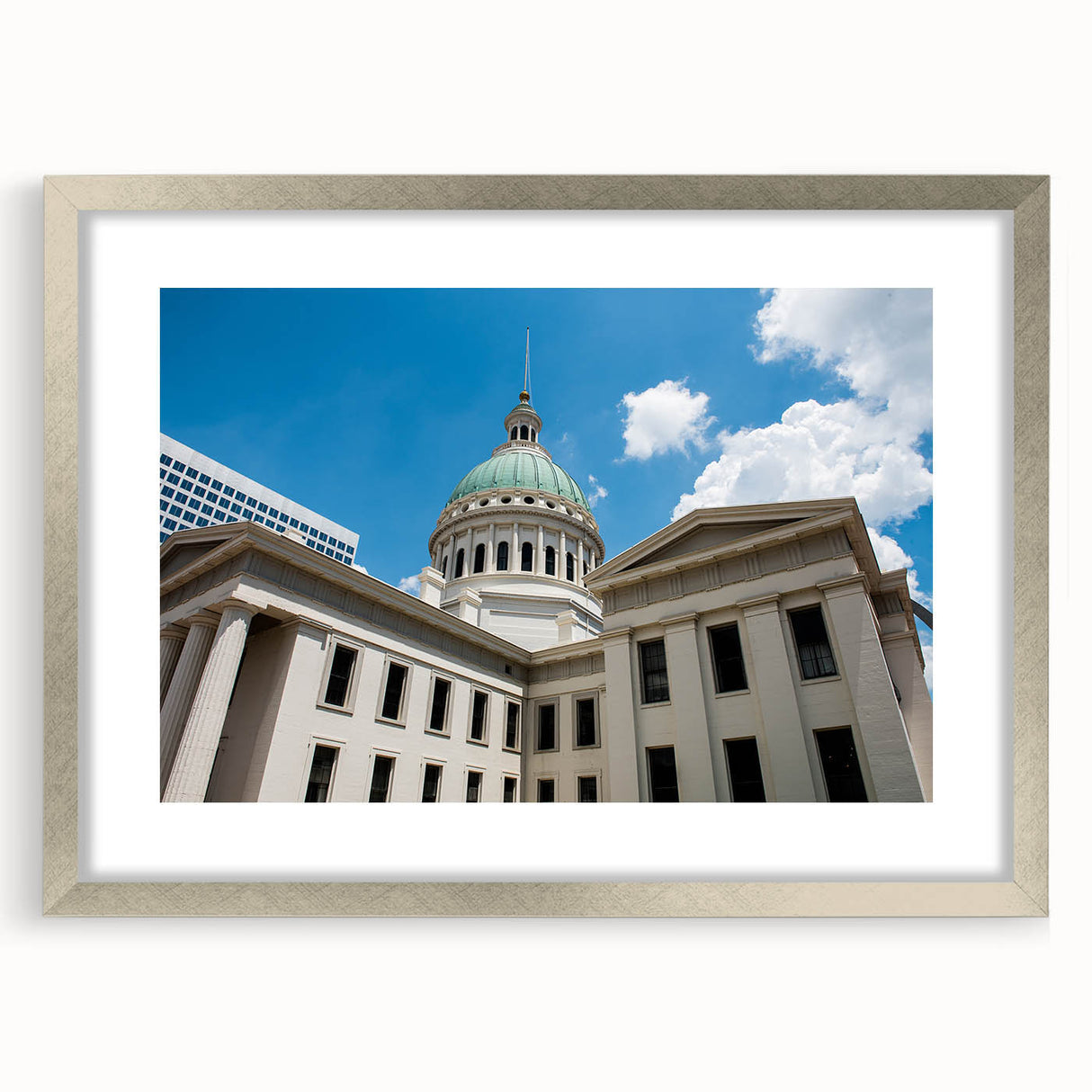 Textured abstract art print of St. Louis scenery in muted earth tones on a framed silver mat, suitable for bedroom decor.