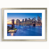 Textured art of abstract Manhattan skyline in muted gray and blue tones on a framed silver mat, suitable for bedroom decor.