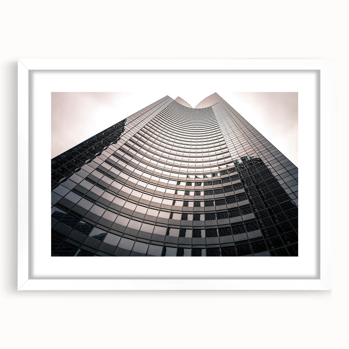 Abstract art print of Seattle skyline in muted gray and blue tones, framed with a white mat, ideal for dining room decor.