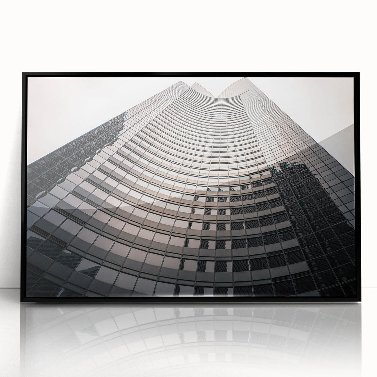 Large abstract wall art depicting Seattle skyline in muted gray and blue tones, framed in black acrylic.