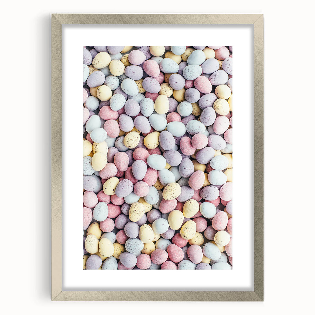 Textured art depicting abstract spring themes in soft green and yellow tones on a framed silver mat.