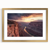 Framed landscape artwork depicting majestic canyons, featuring a gold mat and elegant frame, ideal for home decor or office ambiance enhancement.