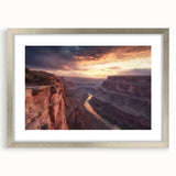 Framed landscape artwork showcasing majestic canyons with a silver mat border, perfect for enhancing home decor with vibrant colors and natural beauty.