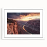 Framed landscape artwork showcasing vibrant canyons in rich earth tones, featuring a white mat and sleek black frame, ideal for enhancing home decor.