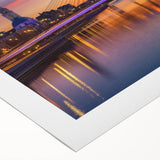Rolled canvas showcasing a vibrant landscape bridge design with rich colors and intricate details, elegantly packaged in a secure cardboard tube for safe transport and display.