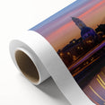 Rolled canvas print showcasing a vibrant landscape bridge design with rich colors and intricate details, securely packaged in a durable cardboard tube for safe shipping.