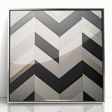 Framed acrylic artwork featuring a modern abstract geometric design in silver tones, showcasing sharp angles and a sleek finish, ideal for contemporary decor.