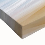 Vibrant close-up of a stretched canvas depicting a serene beach landscape with soft waves and golden sands, perfect for enhancing coastal-themed decor.