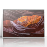 Framed acrylic artwork showcasing a vibrant landscape of canyons in rich earth tones, mounted in a sleek white frame, ideal for modern home decor.