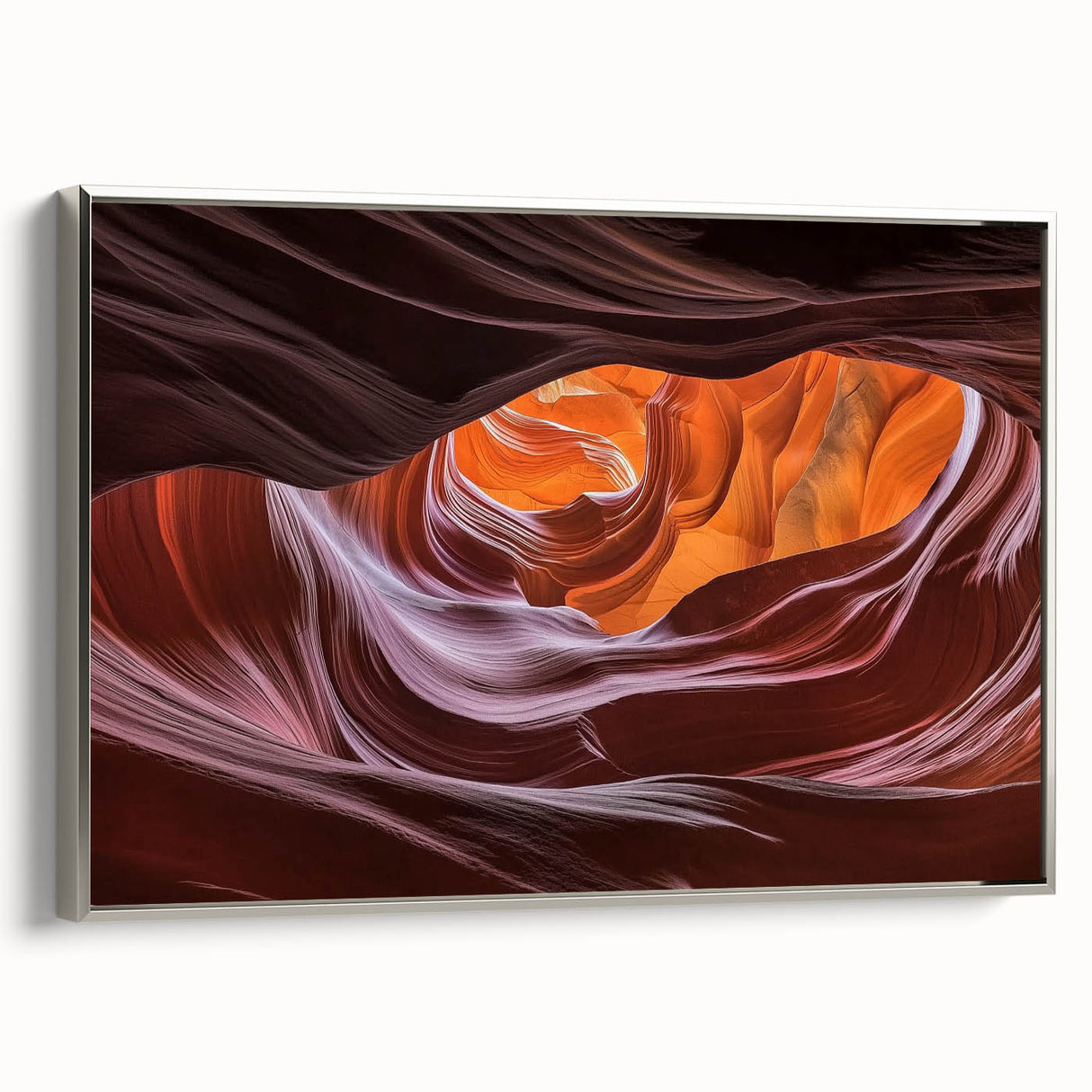 Framed landscape canvas artwork depicting a serene canyon scene, featuring rich earth tones and dramatic rock formations, showcased from a silver side view.
