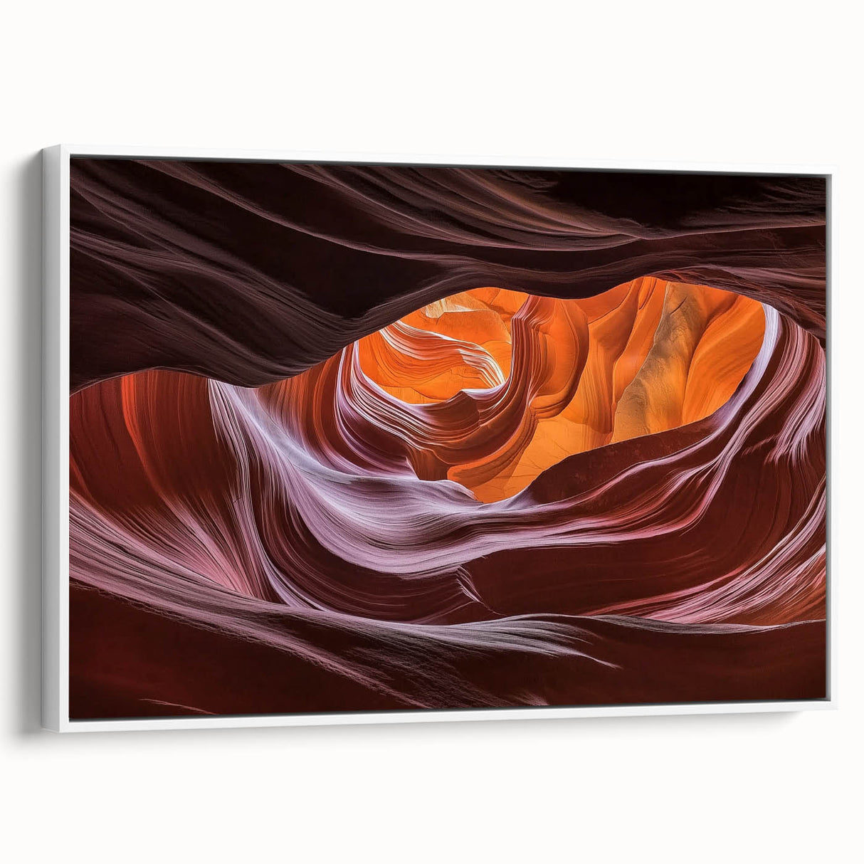 Framed canvas artwork depicting a stunning landscape of canyons in earthy tones, showcased from a side view with a sleek white frame, perfect for home decor.
