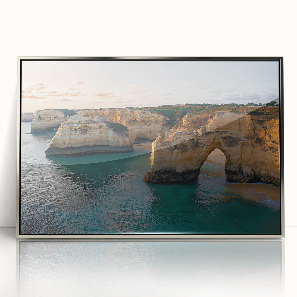 Framed acrylic landscape artwork showcasing dramatic cliffs and serene ocean waves, highlighted by a silver frame, ideal for modern home decor.