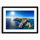 Black-framed landscape artwork showcasing rugged cliffs against a vibrant sunset, with a white mat for an elegant presentation, perfect for home decor.