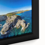 Close-up of a framed canvas depicting dramatic cliffs against a vibrant sunset, showcasing rich colors and intricate details ideal for modern home decor.