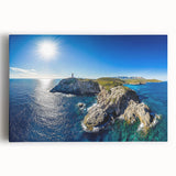 Stretched canvas artwork depicting a dramatic landscape of towering cliffs against a vibrant sunset, perfect for home decor or office enhancement.