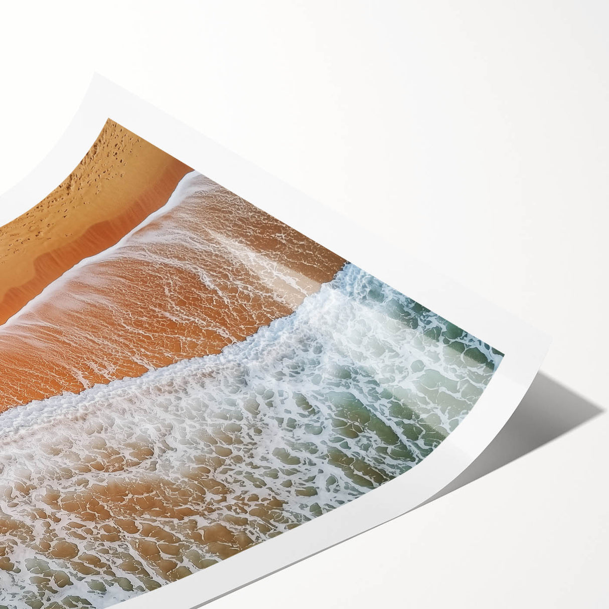 Vibrant rolled print of a serene beach landscape featuring soft waves and golden sand, elegantly packaged in a protective cardboard tube for easy display.