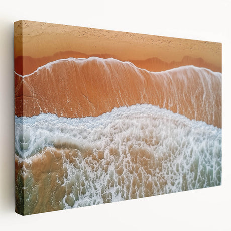 Stretched canvas artwork depicting a serene beach landscape with soft waves and a vibrant sunset, showcasing warm hues of orange and blue, ideal for coastal home decor.