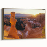 Framed canvas artwork depicting a stunning landscape of canyons with rich earthy tones and a gold frame, ideal for enhancing home decor and adding a touch of elegance to living spaces.