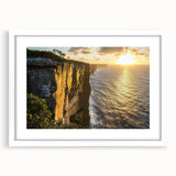 Framed landscape artwork showcasing dramatic cliffs and serene ocean views, presented with a white mat and sleek frame, ideal for home decor.