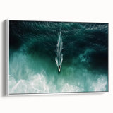 Framed canvas artwork depicting a serene beach landscape with gentle waves and a clear blue sky, showcased in a sleek white frame, enhancing coastal home decor.